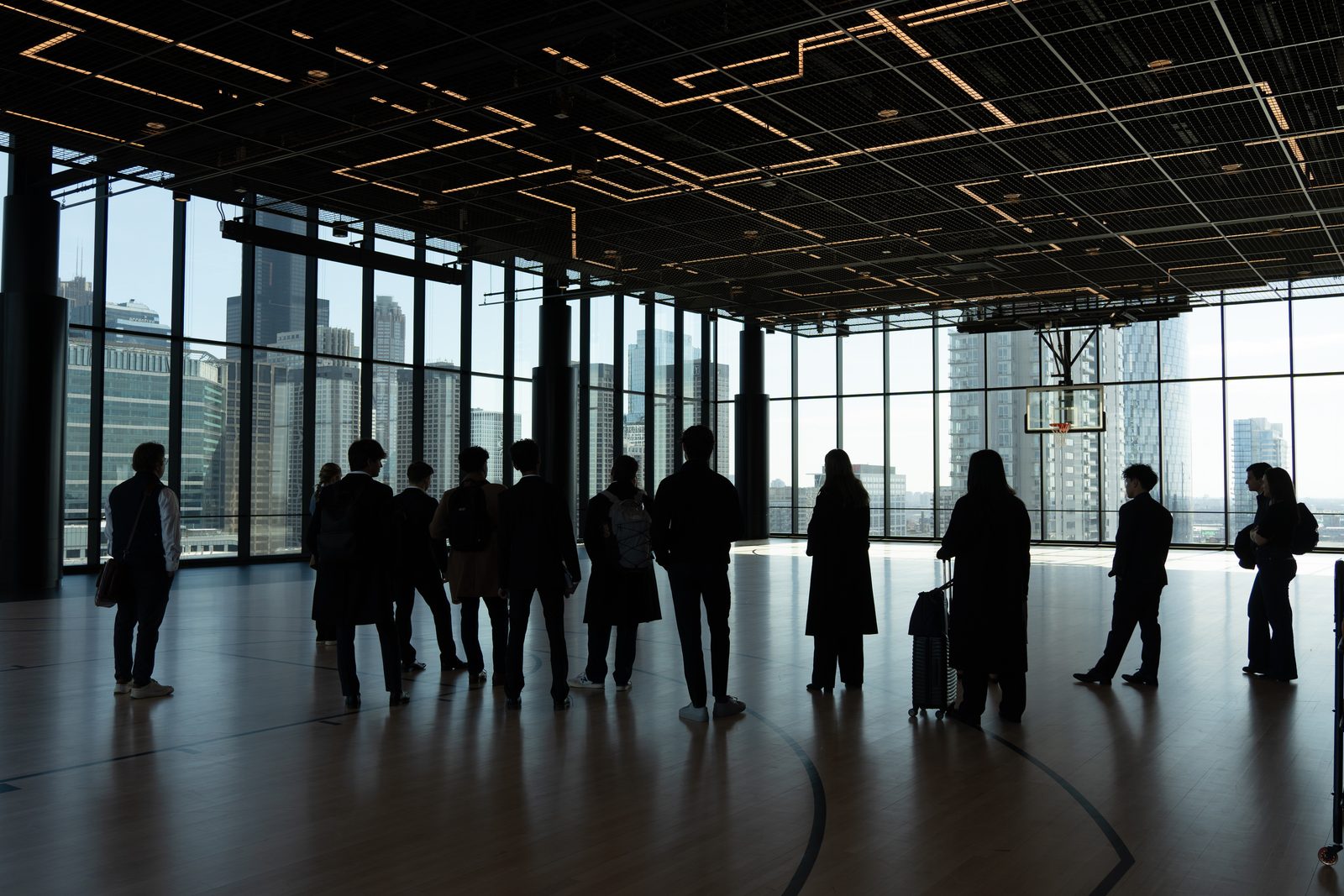 The group in a glass-walled space with the skyline behind them.