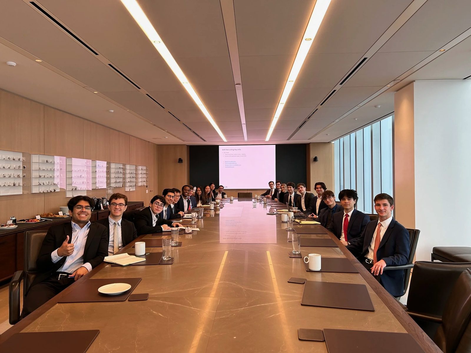 Members along a boardroom table during a firm's presentation.